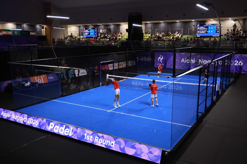 Lebanon’s Tamim El Hallak and Ralph Tohme (front) serve against Japan’s Teruaki Ando and Shinnosuke Nakamura during the men’s pairs padel first round match at the Nagoya City Highashi Sports Center in Nagoya September 28, 2026. — AFP pic
