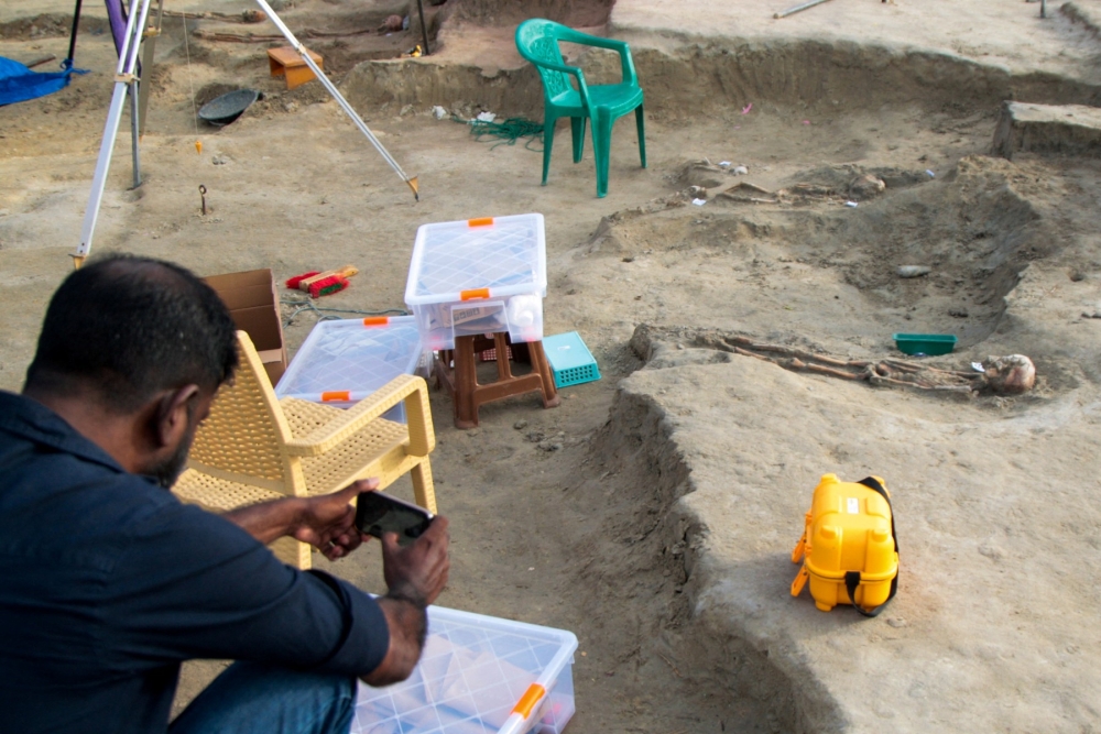A man takes a picture of human remains at the Chemmani mass grave in Jaffna on July 23, 2025, where authorities carried out excavations and forensic tests to identify the remains. — AFP pic
