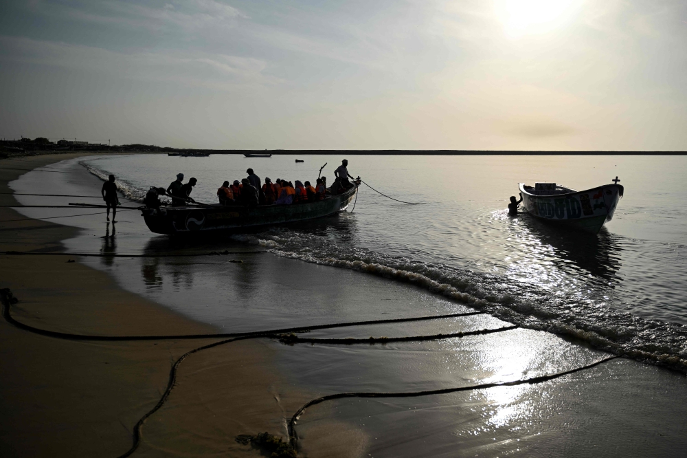 This photograph taken on September 9, 2026 shows fishing community members getting into the boat to travel to Kariyachalli Island, off the coast of Thoothukudi in India’s Tamil Nadu state. — AFP pic
