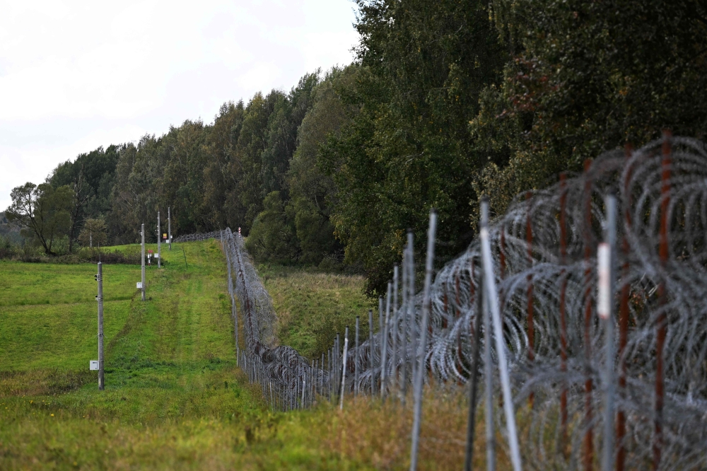 A razor-wire boundary fence is seen along the Polish-Lithuanian border with the Russian exclave of Kaliningrad near the village of Grzybina, Podlaskie Voivodeship, near the Suwalki Gap on September 26, 2026. — AFP pic