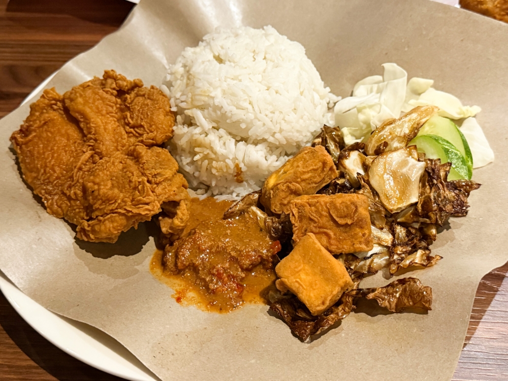Ayam Gepuk Golden Boy style wins with that juicy fried chicken chop, pounded chili sauce drizzled with a roasted cashew sauce, fried cabbage, fried beancurd and ‘tempeh’. — Picture by Lee Khang Yi