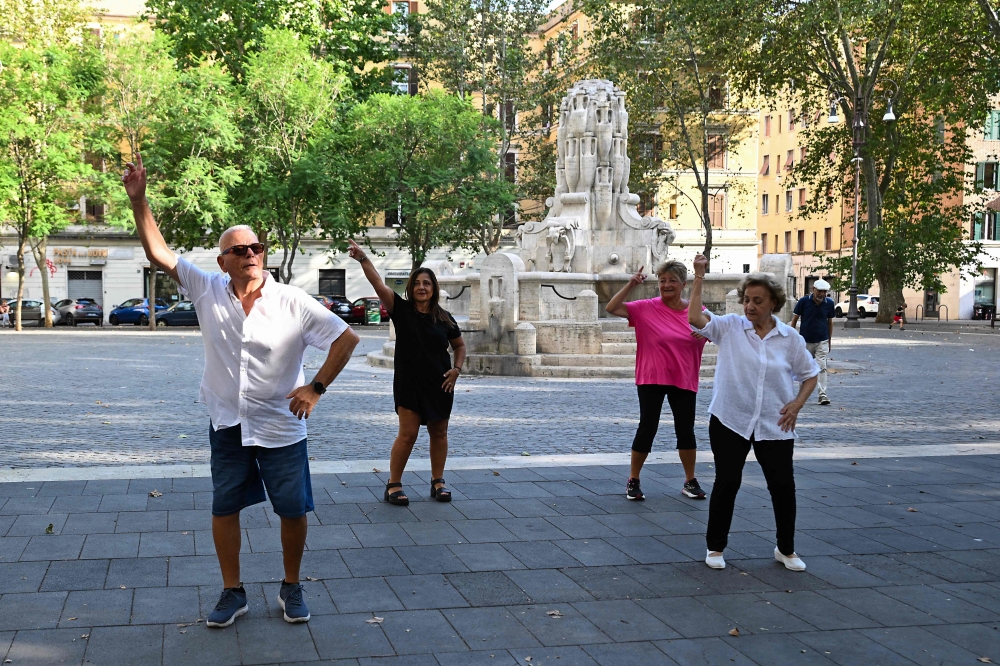 People dance at Piazza Testaccio in Rome, Italy on August 13, 2026. — AFP pic