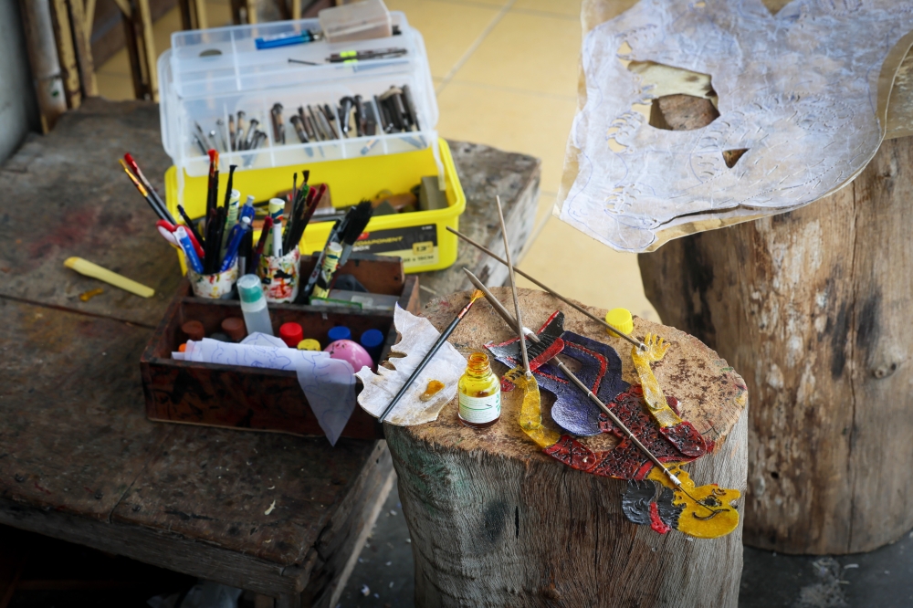 Special pigments are applied to the cowhide surface to bring out the colors of *wayang kulit* (shadow puppet) figures—a process that truly tests precision and patience. — Bernama pic
