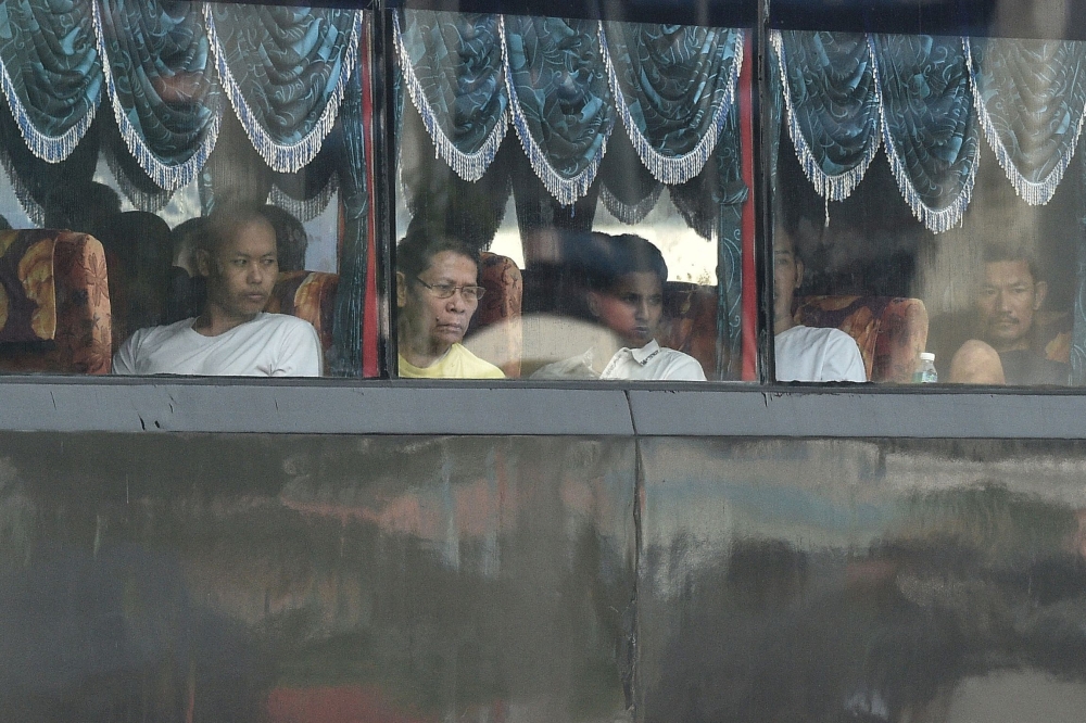 A bus carrying Myanmar nationals being repatriated from Malaysia to their homeland, is seen heading toward to navel base in Lumut, on the outskirts of Kuala Lumpur on September 29, 2026. Malaysia began sending back around 1,500 Myanmar nationals on September 29, AFP journalists saw, launching a scheme rights groups say may endanger migrants by returning them to the war-torn country. — AFP pic