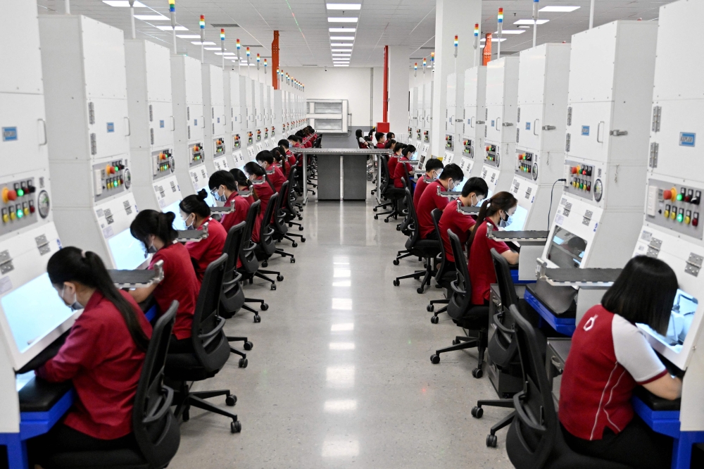 Workers craft jewellery at Pandora's new manufacturing plant in Ho Chi Minh City on October 1, 2026, as the world's biggest jewellery brand opened the facility it said will be able to produce up to 60 million pieces each year. — AFP pic