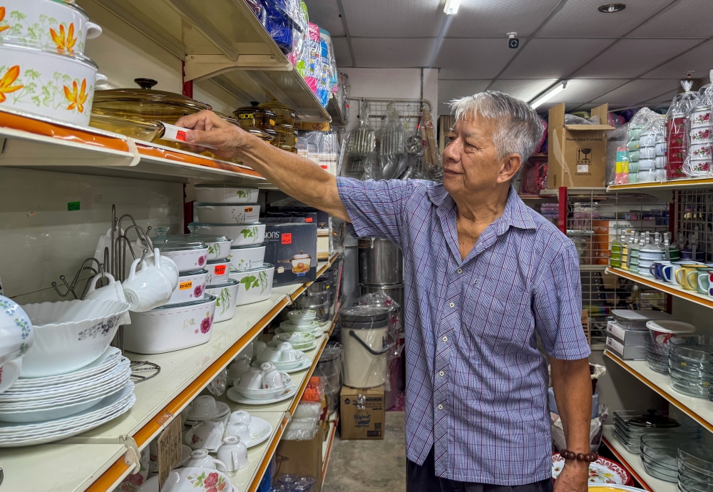 Trader Fu Chee Kat said changing customer patterns have forced him to scale back his business in Rantau Panjang, where he now operates just one shop with one employee. — Bernama pic