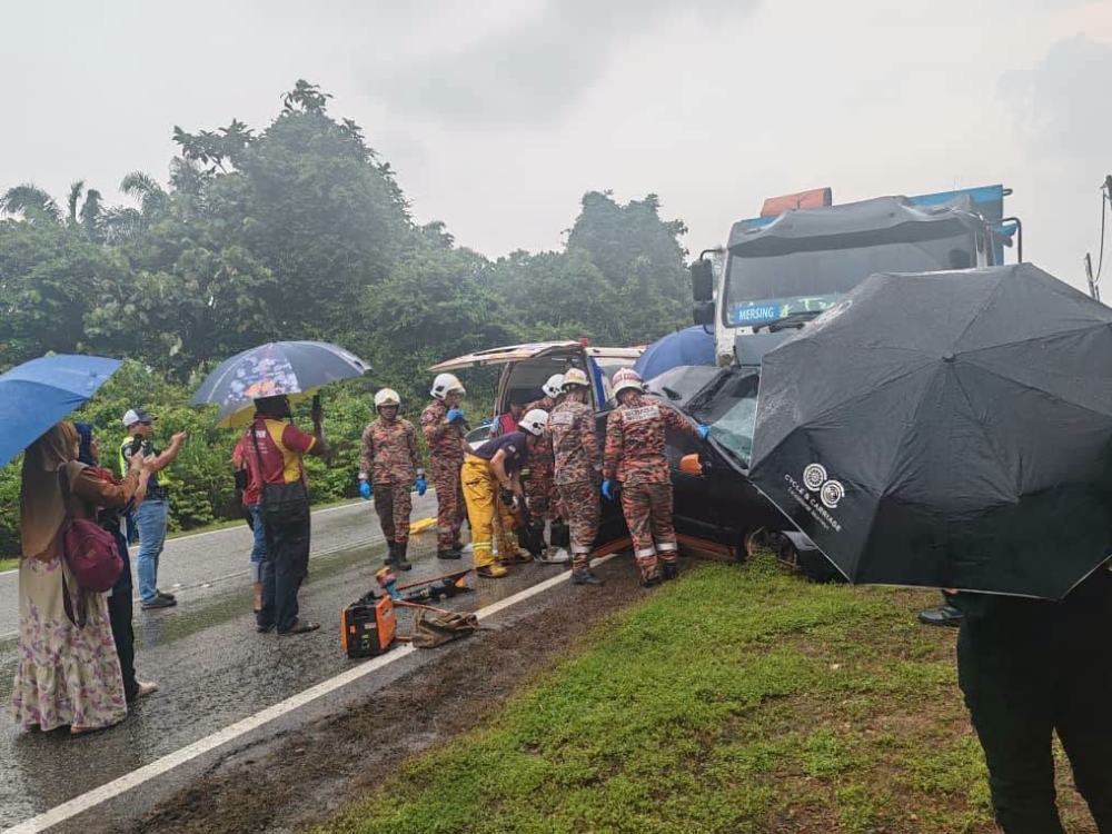 Fire and Rescue Department personnel at the scene of a fatal crash involving a Hyundai Matrix car and a lorry at Kilometre 72.5 of Jalan Batu Pahat-Mersing in Kluang, Johor on October 2, 2026. — Picture from Facebook/This is Johor