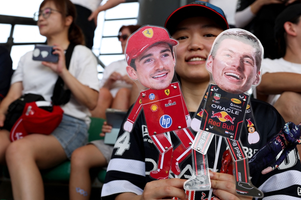 A fan holds cutouts of Ferrari’s Charles Leclerc (left) and Red Bull Racing’s Max Verstappen (right) during qualifying for the F1 Bahrain Grand Prix on October 3, 2026. — AFP pic