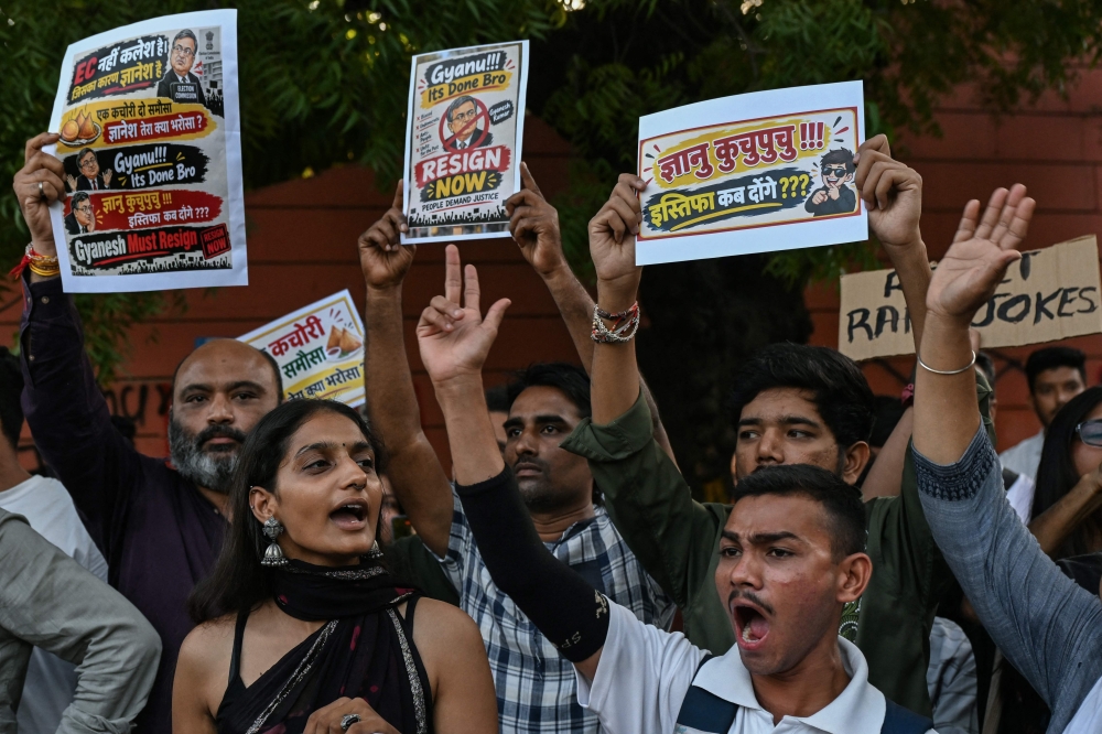 People holding placards take part in a protest demanding the resignation of India's chief election commissioner Gyanesh Kumar over alleged voter-roll irregularities in Ahmedabad on October 2, 2026. — AFP pic