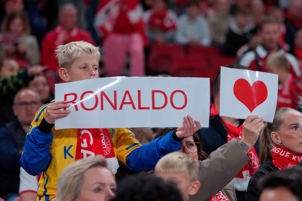 Danish fans show their support for Portugal’s forward Cristiano Ronaldo prior to the Uefa Nations League Group A4 match between Denmark and Portugal at Parken stadium in Copenhagen October 1, 2026. — AFP pic