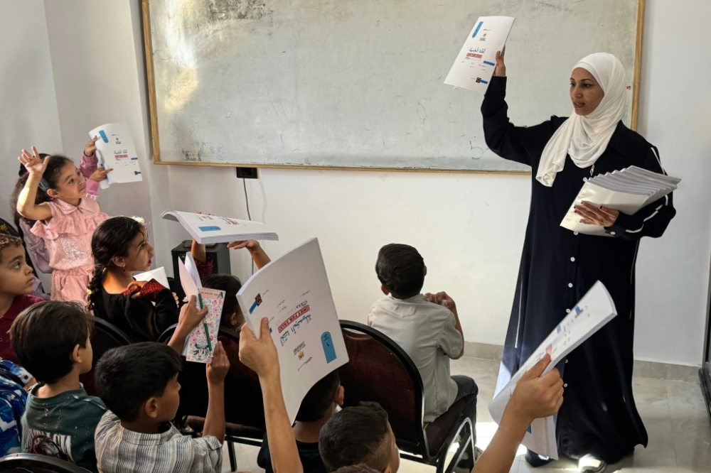In Egypt, a Gazan teacher helps uprooted children by creating a school for them. In Egypt, a Gazan teacher helps uprooted children by creating a school for them.