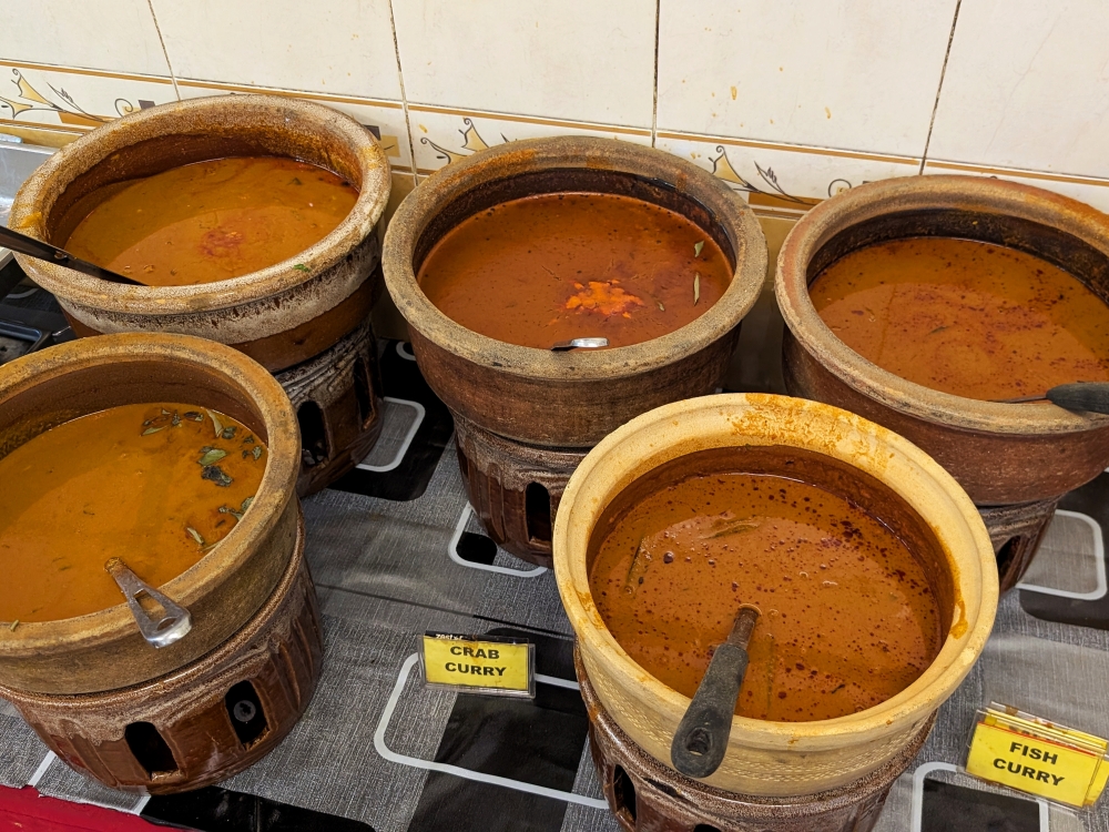 The clay pots that give the restaurant its name are filled with chicken, mutton, crab, fish and vegetable curry. — Picture by Ethan Lau