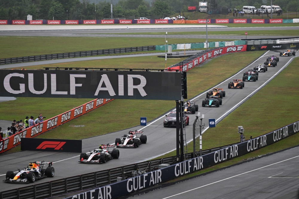 Cars enter the pit lane after the start of theGulf Air Bahrain Grand Prix F1 race was delayed by heavy rain at the Sepang International Circuit on October 4, 2026, which marks F1’s return to Malaysia after a nine-year absence. — AFP pic