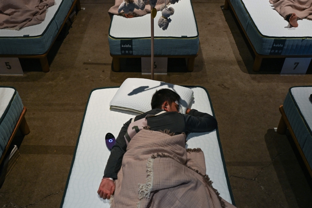 Japan’s sleep-deprived reputation inspired an unusual Tokyo contest where participants competed to see who could sleep best. — AFP pic