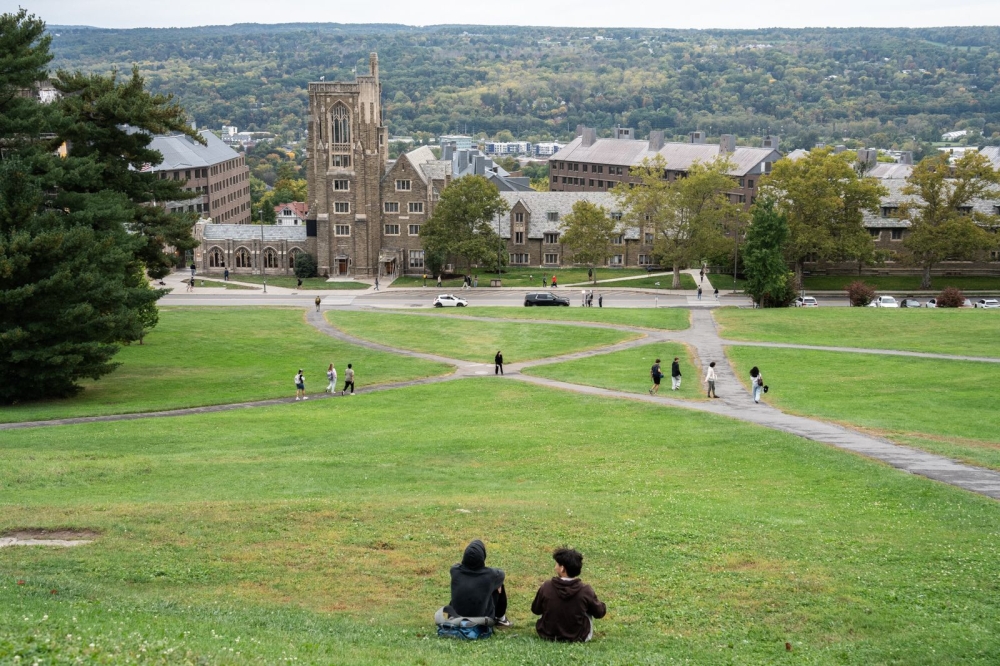 Students sit on Libe Slope on the campus of Cornell University in Ithaca, New York. Among new assessment methods being considered by university educators are pairing written assignments with oral exams and using video debates to curb AI-assisted cheating. — AFP pic