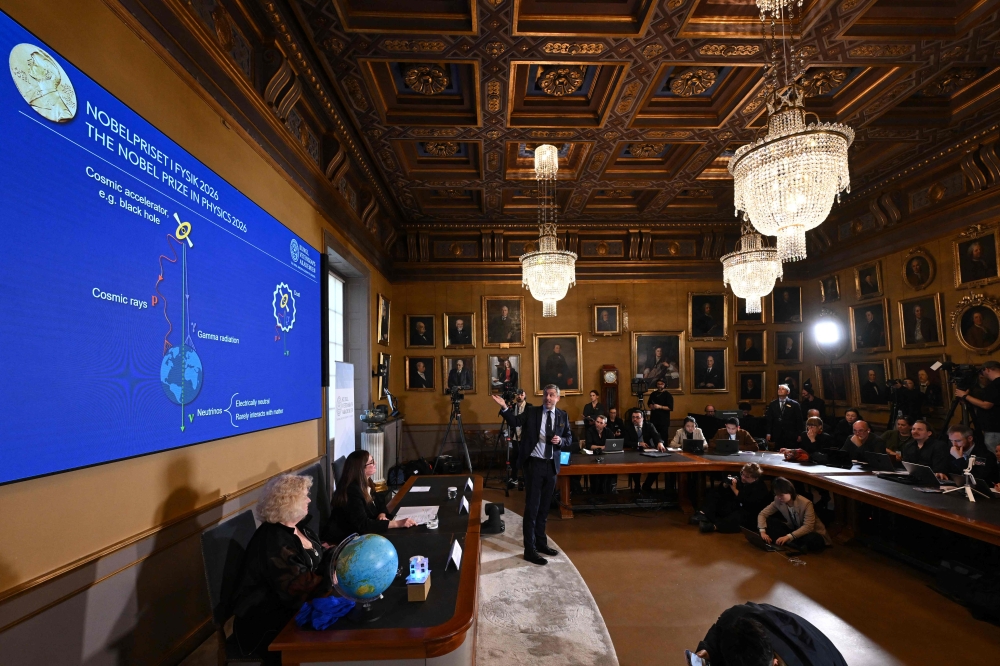 Nobel Committee for Physics member Mark Pearce (right) speaks next to Eva Olsson (left) and Ellen Moons as Belgian physicist Francis Halzen is announced as the 2026 Nobel Prize in Physics winner at the Royal Swedish Academy of Sciences in Stockholm on October 6, 2026. — TT News Agency pic via AFP 