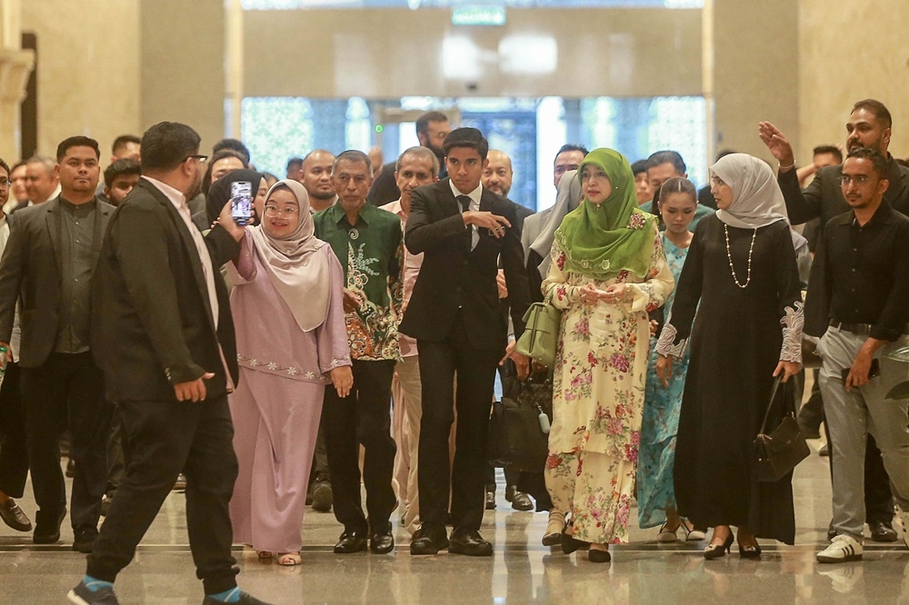 Syed Saddiq along with his supporters and family as well as Bella Astillah as they arrived at the Palace of Justice for his court proceeding in July this year. — Picture by Sayuti Zainudin