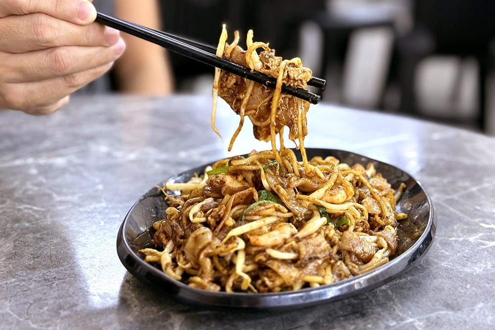 Wetter than your typical ‘char kway teow’ but still full of ‘wok hei’. — Picture by CK Lim