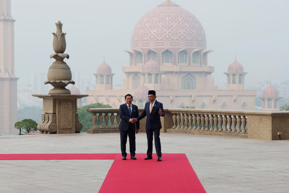 Prime Minister Datuk Seri Anwar Ibrahim (right) shakes hands with Myanmar President Min Aung Hlaing following an official welcoming ceremony during the latter’s two-day official visit to Malaysia, at the Perdana Putra Complex in Putrajaya on October 8, 2026. — Bernama pic
