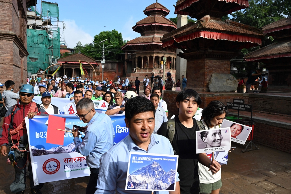 Nepali people take part in a procession to mark the 18th International Everest Day and the 72nd anniversary of the first ascent of Mount Everest in Kathmandu on May 29, 2025. — AFP pic
