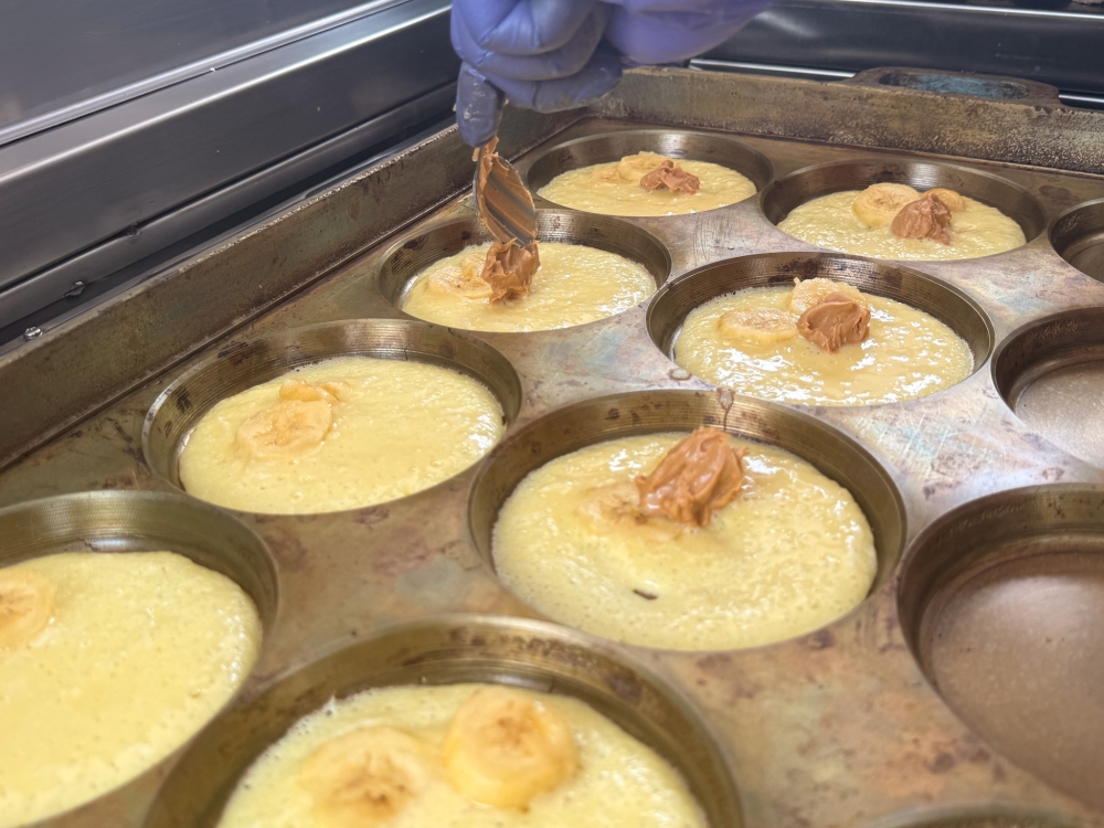 Peanut butter with coarsely chopped nuts is dolloped over the pancakes topped with bananas. — Picture by Lee Khang Yi