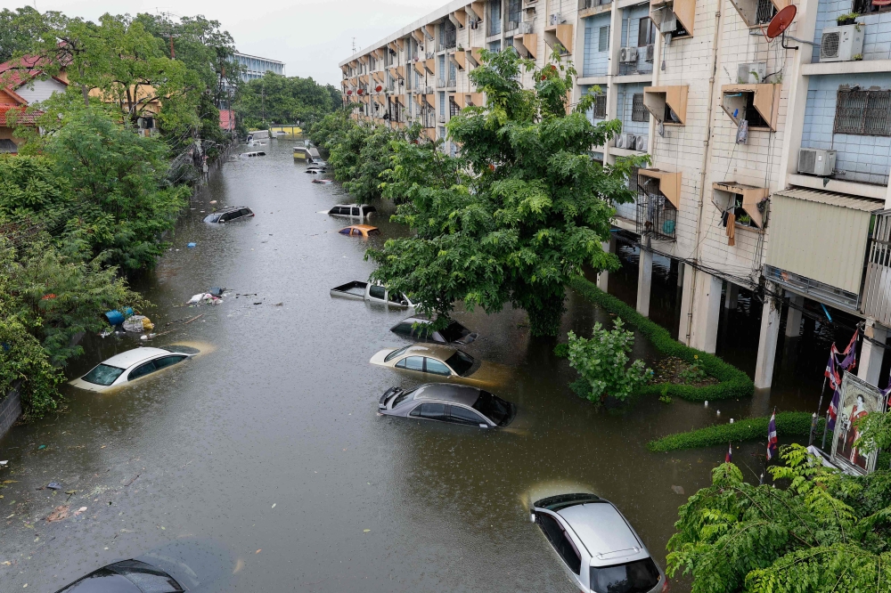 Floodwaters submerge cars next to residential buildings after heavy rain in Bangkok, Thailand on September 26, 2026. — Thai News Pix/AFP pic