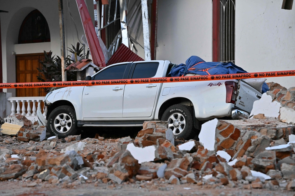 This view shows a collapsed building and a damaged car after a 7.6-magnitude earthquake struck the country, in Penonome, Panama, on October 9, 2026. — AFP pic