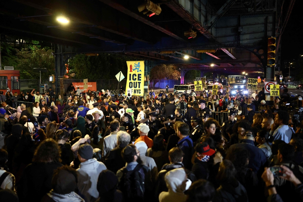 Protesters gather near the scene where a man was shot by an Immigration and Customs Enforcement (ICE) officer during an operation in the Bronx borough of New York on October 8, 2026, according to local media and police. — AFP pic