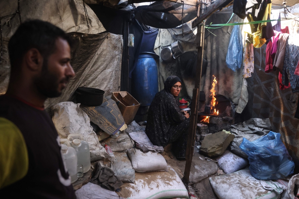 Morsi and Nihaya Al-Masri, a displaced Palestinian couple from Beit Hanoun, are seen at their makeshift shelter in Khan Yunis, in the southern Gaza Strip, October 6, 2026. — AFP pic
