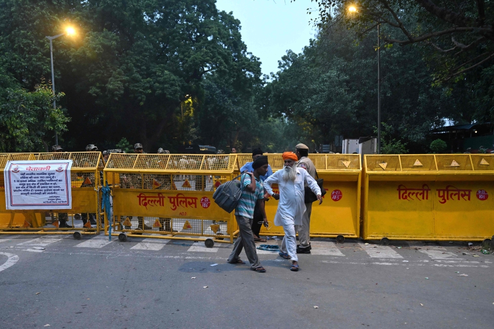 Pedestrians walk away after police personnel barricaded a street ahead of a protest by the youth-led Cockroach Janata Party (CJP) demanding the resignation of India’s Chief Election Commissioner over alleged ‘special intensive revision’ (SIR) voter-roll irregularities, near Jantar Mantar in New Delhi October 10, 2026. — AFP pic