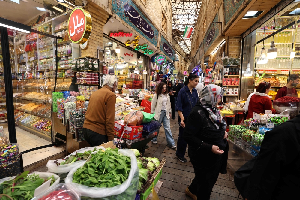Shoppers walk along an alley at the Tajrish Bazaar. — AFP pic