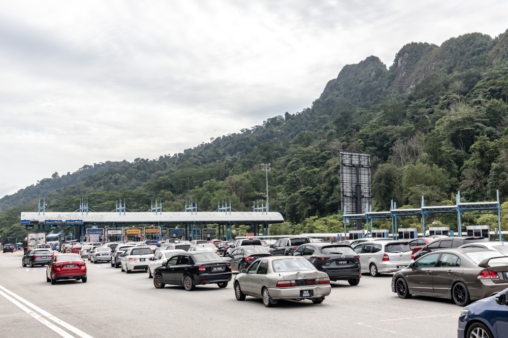 Motorists must continue to follow the lane markings and signage rather than assuming that every part of the highway has already become barrier-free. — Picture by Firdaus Latif