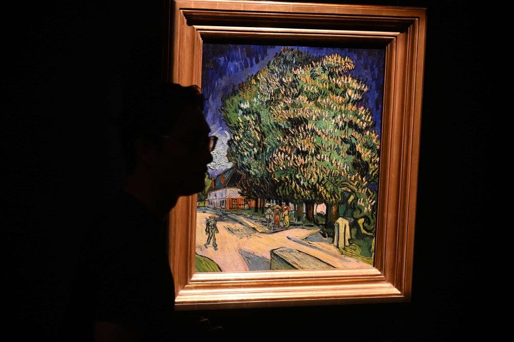 A visitor views Vincent van Gogh’s painting ‘Châtaigniers en fleurs’ (Chestnut Trees in Blossom) during an auction preview in Hong Kong on October 13, 2026, ahead of its sale in New York in November. — AFP pic