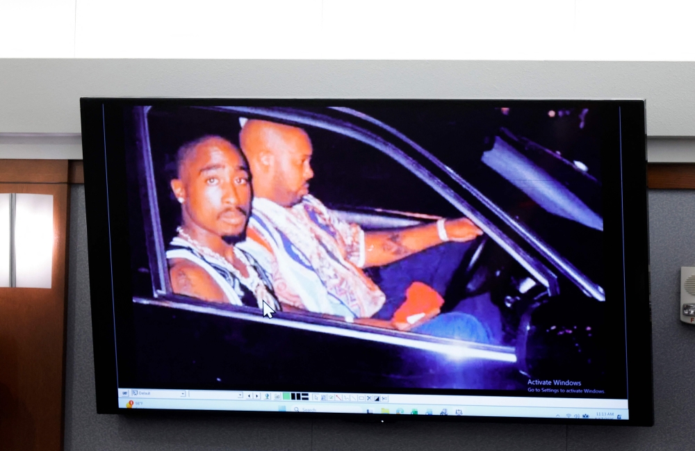 A 1996 photo of rapper Tupac Shukur (left) and Marion ‘Suge’ Knight is  displayed during the Duane Davis murder trial, related to the 1996 killing of the rapper, in Las Vegas August 17, 2026. — AFP pic