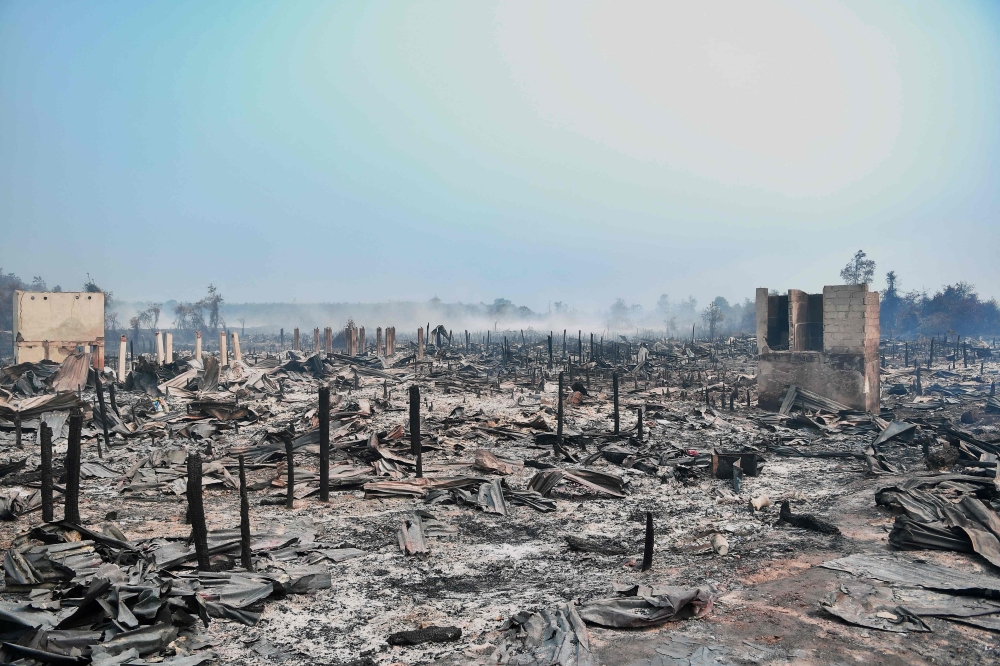 Residents inspect homes destroyed by a forest fire at Simpang Rimba in the Bangka Selatan district of Bangka Belitung province October 13, 2026. — AFP pic