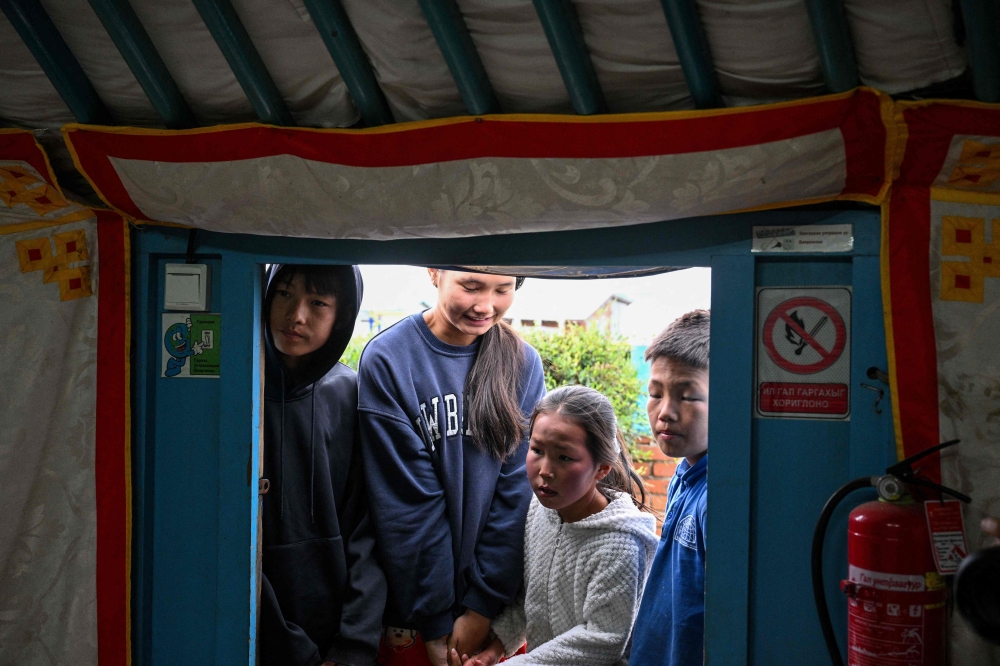 Children arrive to have their teeth checked at a mobile dental clinic inside a traditional Mongolian ger in Ulaanbaatar. — AFP pic