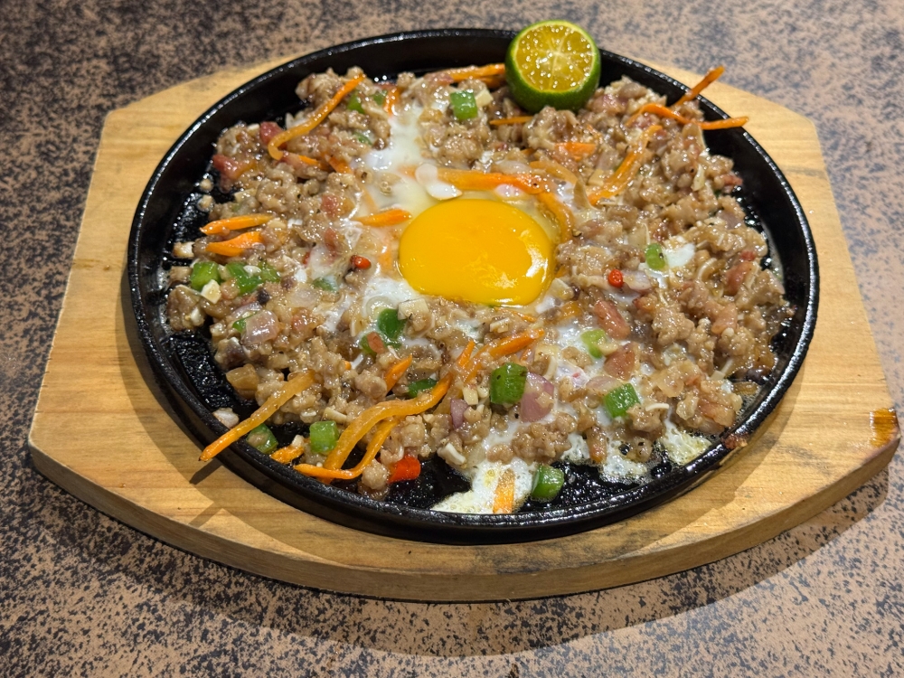 Sisig is great with alcohol or paired with rice as you get a mix of textures from the finely diced pork and pig’s ears mixed with the egg. — Picture by Lee Khang Yi
