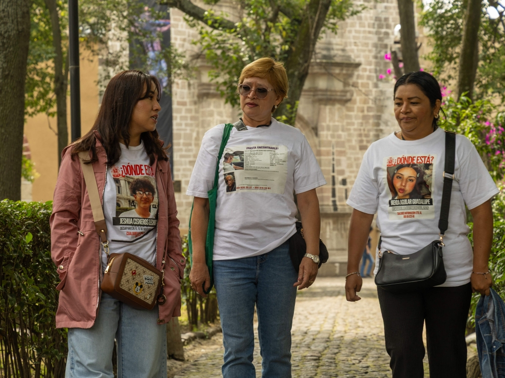(Left to right) Karla Lechuga, Alejandra Romero, and Ingrid Loana Baca, members of the Lirios Buscadores Izcalli collective, walk in the courtyard of at a church in Tepoztlan, state of Morelos, Mexico, on August 29, 2026 in search of new leads for children who disappeared during the brutal cartel turf war that lasted years. — AFP pic