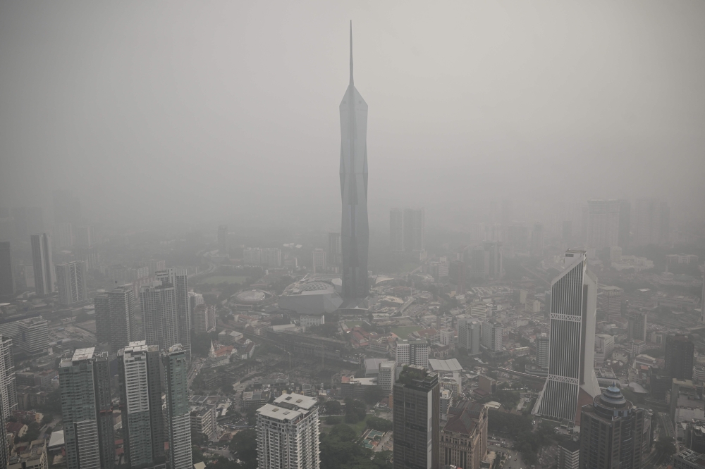 Buildings are shrouded in haze from Indonesian fires in Kuala Lumpur on October 16, 2026. — AFP pic