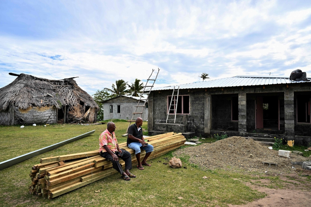 Villagers watch the construction of a new house on higher ground near Naidiri Marine Biodiversity Park in Fiji on October 5, 2026, as coastal communities face growing climate change risks. — AFP pic