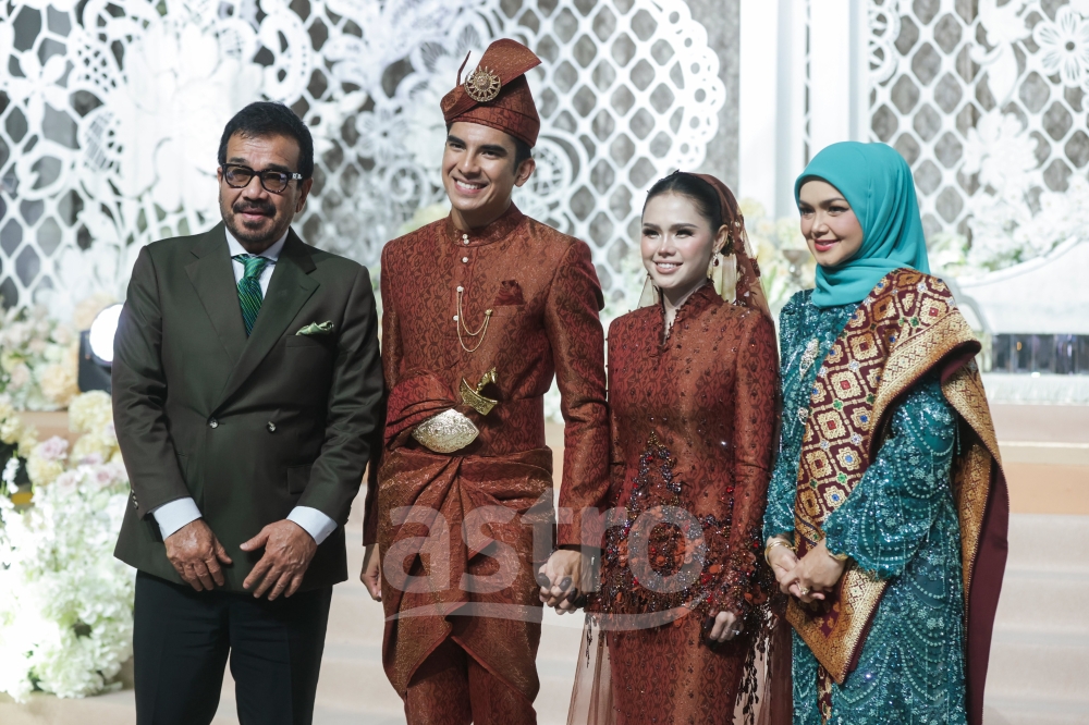 Newlyweds Muar MP Syed Saddiq Syed Abdul Rahman (centre left) and Bella Astillah (centre right) pose for a photograph with Datuk Seri Siti Nurhaliza (far right) during their wedding reception at Malaysia International Trade and Exhibition Centre in Kuala Lumpur on October 18, 2026. — Picture courtesy of Astro