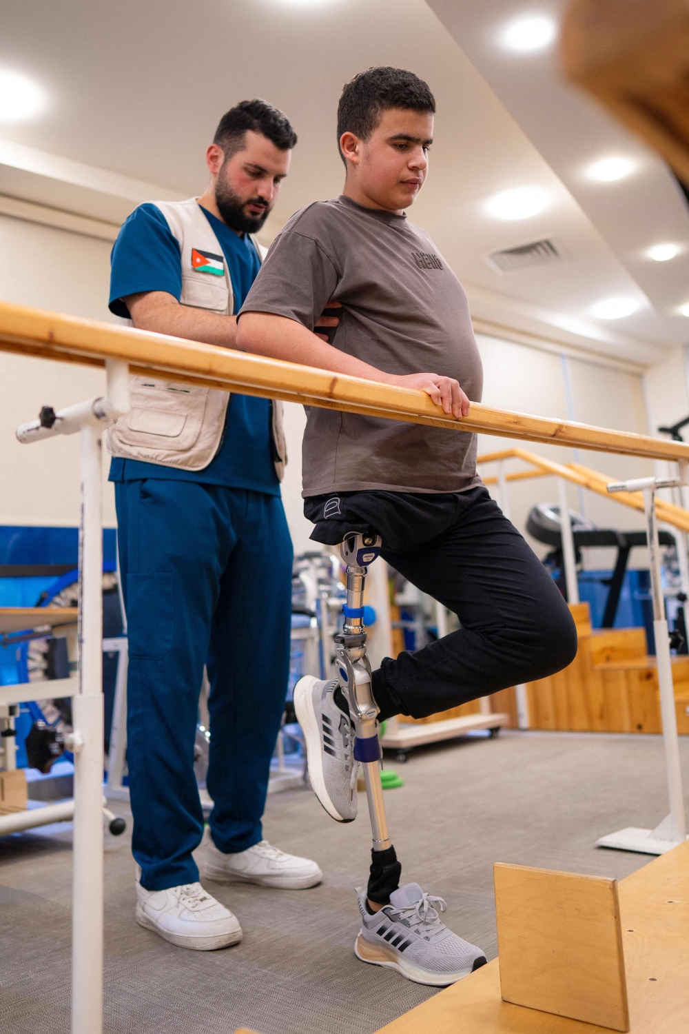 Zuhdi Abou Shanab, a 17-year-old Palestinian boy who lost his entire right leg below the hip during the war in Gaza, is assisted during rehabilitation treatment with his prosthetic at a medical centre in Amman October 13, 2026. — AFP pic