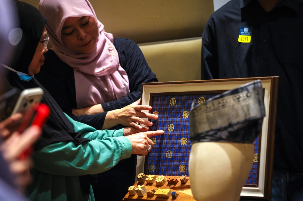 Visitors examine traditional ‘telepuk’ motifs and wooden printing blocks at the ‘Telepuk: The Imprint of Heritage’ exhibition, which runs until December 31 at the Royal Selangor Visitor Centre in Kuala Lumpur. — Bernama pic