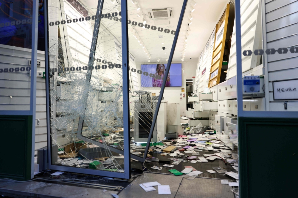 A looted shop in Lille. — AFP pic
