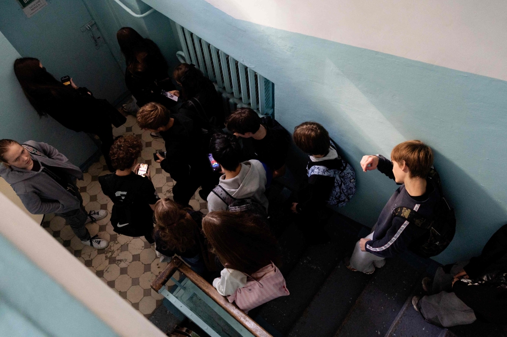 Orest and his classmates head down to the shelter during an air alert in Kyiv on October 13, 2026. — AFP pic 