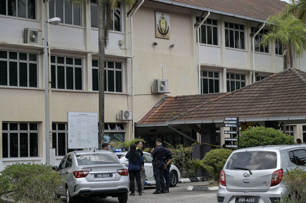 Police vehicles are seen outside a school in Bandar Utama following a stabbing incident in Petaling Jaya on October 14, 2025. — Bernama pic