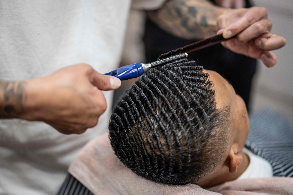 This photo taken on August 27, 2026 shows Tekisasu, an active yakuza gangster allied to a major clan, having his hair permed at a barbershop in Tokyo. — AFP pic