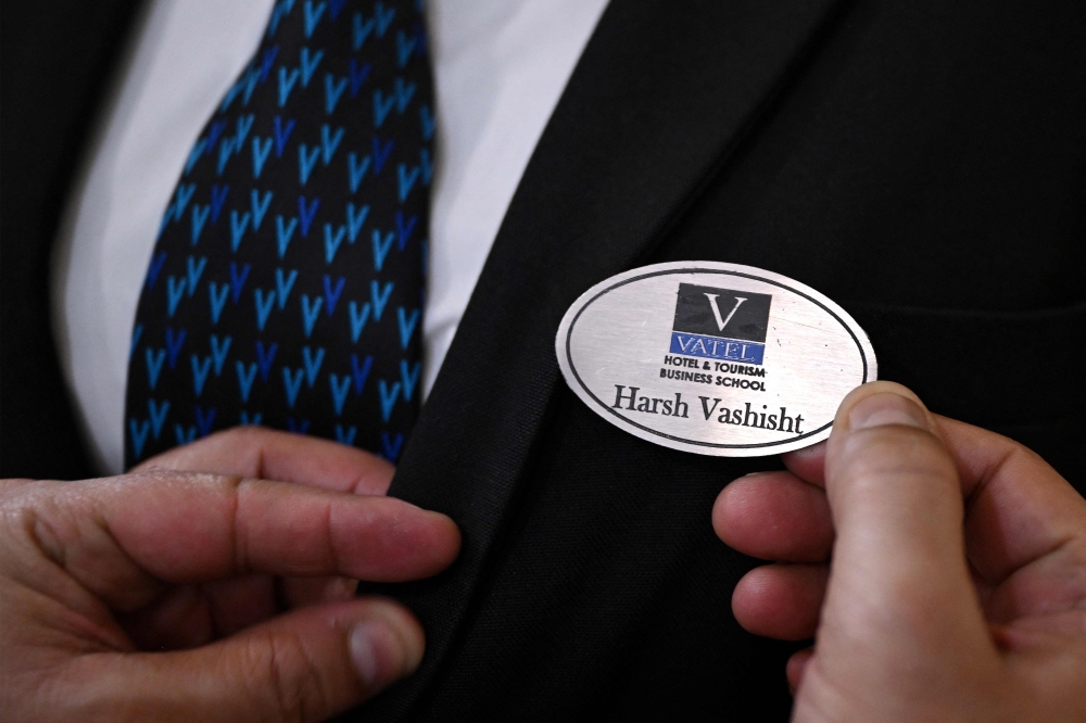 This photograph taken on September 22, 2026 shows a staff member putting a badge on a mannequin during a class at the Vatel Hotel and Tourism Business School in Gurugram. — AFP pic