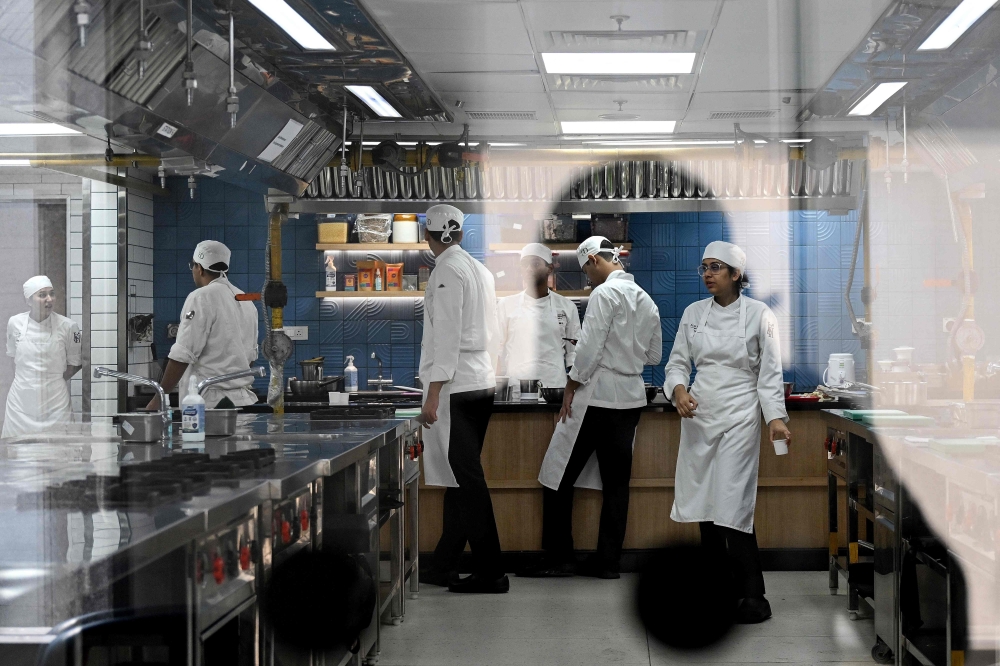 This photograph taken on September 22, 2026 shows student chefs working in a kitchen at the Ecole Ducasse, a French culinary school in Gurugram. — AFP pic