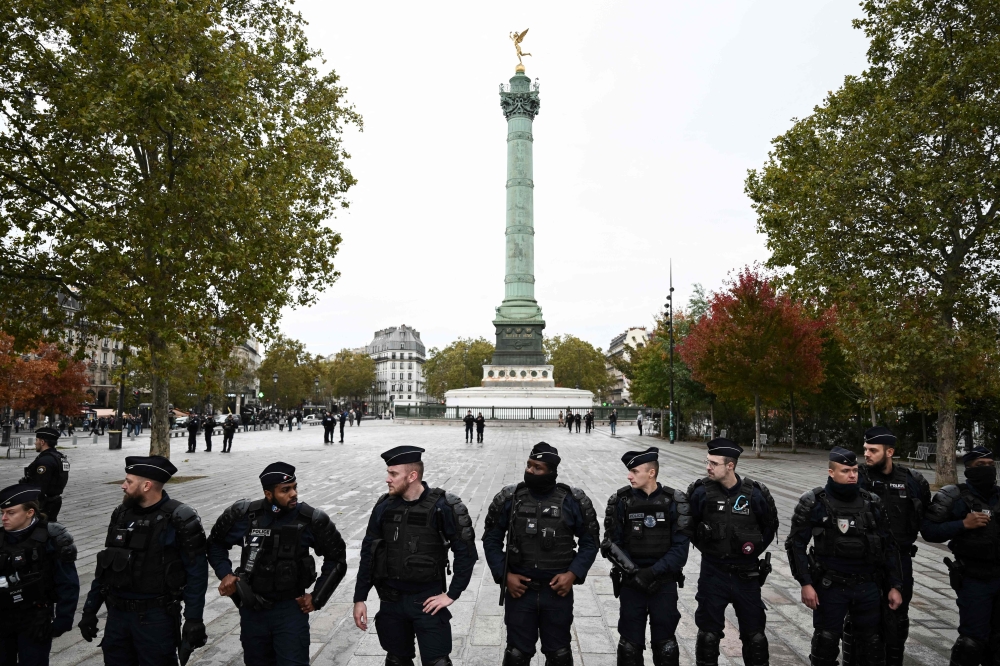 Police officers stand guard at the Place de la Bastille. — AFP pic